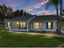 Charming single-story home with screened porch, manicured lawn, and mature landscaping providing excellent curb appeal at 6194 Sanderling Dr, Lakeland, FL 33809