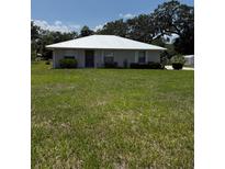 Charming single-story home with a large lawn and mature trees in a serene setting at 629 N Cleveland Ave, Fort Meade, FL 33841