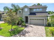 Charming two-story home featuring a paver driveway and well-manicured landscaping at 843 Christina Chase Dr, Lakeland, FL 33813