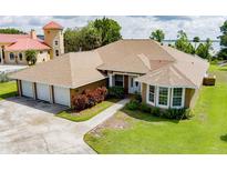 Lovely single-story home with a well-manicured lawn and three-car garage, offering ample space and curb appeal at 9093 S Bay Dr, Haines City, FL 33844