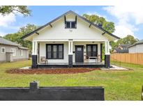 Charming bungalow with black and white trim, inviting front porch and well-maintained front yard at 911 S Missouri Ave, Lakeland, FL 33803