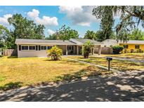 Charming single-story home with a carport and front yard featuring palm trees at 960 Lila St, Bartow, FL 33830