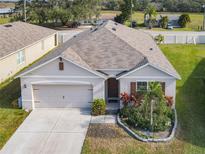 Charming single-story home with a well-manicured lawn and a two car garage at 120 Grove Branch Rd, Winter Haven, FL 33880