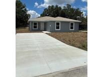 Charming single-story home with a spacious concrete driveway at 1329 Tom Watson Rd, Lakeland, FL 33801