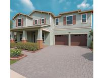 Charming two-story home featuring a two-car garage, covered porch, and inviting curb appeal at 13525 Gorgona Isle Dr, Windermere, FL 34786