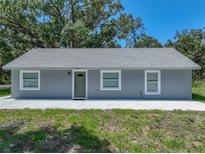 Charming single-story home featuring a gray exterior, a new gray roof, and manicured landscaping at 1415 Southern Ave, Lakeland, FL 33803