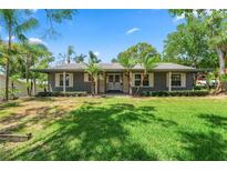 Charming single story home with mature landscaping and covered entry at 1628 Lakewood S Dr, Lakeland, FL 33813