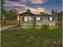Charming single-story home with a well-manicured lawn and a newly installed wooden fence at 1728 Bush Ave, Lakeland, FL 33805