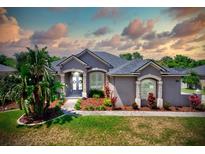 Charming single Gathering home featuring a beautiful, manicured lawn and mature landscaping at 2032 Indian Sky Cir, Lakeland, FL 33813