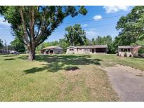 Well-maintained single-Gathering home with a detached garage and spacious front yard at 2145 Limedale Rd, Lakeland, FL 33809