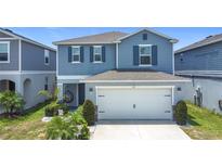 Charming two-story home featuring a two-car garage, covered entry, and well-maintained landscaping at 511 Preserve Pointe Blvd, Davenport, FL 33837