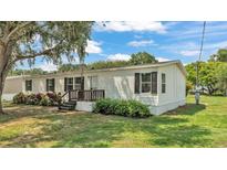 Charming single-story home boasts a well-manicured lawn and inviting front porch, perfect for relaxing outdoors at 5751 Cherry Tree Dr, Lakeland, FL 33811