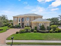 Stately two-story home with manicured lawn, stone accents, and brick driveway at 6542 Eagle Ridge Way, Lakeland, FL 33813