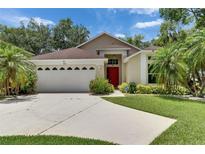 Charming single-story home with a well-manicured lawn and a bright red front door at 1003 Clearpointe Way, Lakeland, FL 33813