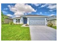 Charming single-story home with a well-manicured lawn and inviting entranceway at 1529 Leamington Ln, Winter Haven, FL 33884