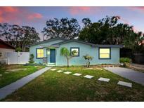 Charming single-story home featuring a manicured lawn and stepping stone walkway at 1648 Skinner St, Lakeland, FL 33801