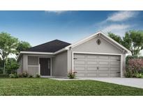 Charming single-Gathering home showcasing a well-maintained lawn and a two-car garage at 1906 Daystar Dr, Haines City, FL 33844