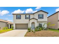 Charming two-story home featuring a neutral color palette and well-maintained landscaping at 2546 Red Egret Dr, Bartow, FL 33830