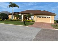 Charming single-story home with a well-manicured lawn and a convenient two-car garage at 2936 Grasslands Dr, Lakeland, FL 33803