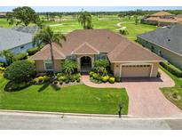 Beautiful home with mature landscaping, brick driveway, and golf course views at 2936 Grasslands Dr, Lakeland, FL 33803