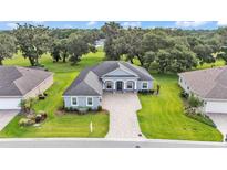 Stunning single-story home boasts lush landscaping and a brick-paved driveway in a serene neighborhood at 3176 Pearly Dr, Lakeland, FL 33812