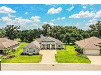 Stunning single-story home featuring a paver driveway, lush lawn, and decorative stone accents at 3176 Pearly Dr, Lakeland, FL 33812