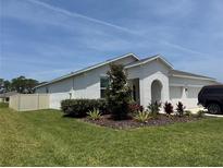 Charming single-story home featuring a well-manicured lawn, white exterior, and a two car garage at 3966 Willowbrook Dr, Edgewater, FL 32141