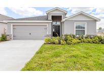 Charming single-story home featuring a two-car garage and well-maintained lawn at 4515 Rapallo Ave, Winter Haven, FL 33884
