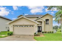 Charming two-story home with a well-manicured lawn and an attached two-car garage at 601 Peninsular Dr, Lakeland, FL 33813