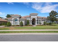 Stunning single-story home with a beautifully landscaped front yard and barrel tile roof at 6527 Eagle Ridge Way, Lakeland, FL 33813