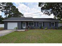 Charming single-story home featuring a brick facade, well-manicured lawn, and inviting front porch at 5732 Sawyer Rd, Lakeland, FL 33810