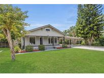 Charming home with a covered porch, large front yard, and covered parking at 1013 Pennsylvania Ave, Lakeland, FL 33803