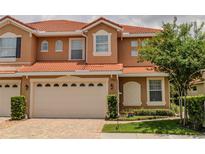 Charming two-story home with a red tile roof, an attached two-car garage, and well-maintained landscaping at 1970 Michael Tiago Cir, Maitland, FL 32751