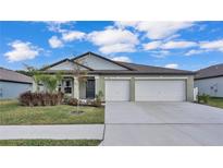 Charming single-story home with a three-car garage and well-manicured lawn at 2966 Flying Blackbird Rd, Bartow, FL 33830