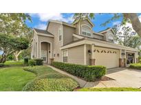 Charming two-story home featuring a well-manicured lawn and a two-car garage at 3107 Stonewater Dr, Lakeland, FL 33803