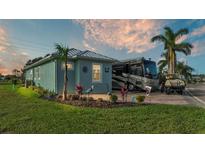 Charming home with a neatly landscaped yard, RV parking, and a golf cart at 3270 Green Heron Dr, Polk City, FL 33868