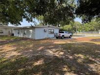 View of the building exterior, mature landscaping, with truck parked on the side at 3651 Rifle Range Rd, Winter Haven, FL 33880