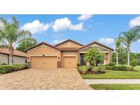 Beautiful home featuring a brick driveway, a two-car garage, and manicured landscaping at 3934 Aquilla Dr, Lakeland, FL 33810
