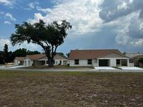 New single-story home with a covered entrance and two-car garage on a spacious lot at 4036 Oak Loop, Mulberry, FL 33860
