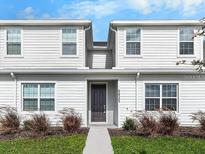 Inviting exterior view of a two-story home with neat landscaping and neutral siding at 5768 Anders Way, St Cloud, FL 34771