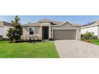 Inviting single-story home featuring a well-maintained lawn and a neutral color palette at 606 Fairview Ave # 244, Haines City, FL 33844