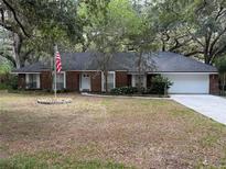 Charming one-story brick home with a large two-car garage, traditional design, and an inviting front yard at 6116 Sweet Gum Run, Bartow, FL 33830