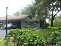 Charming home with a carport and lush landscaping, creating an inviting curb appeal at 6632 Sweetbriar Ln, Lakeland, FL 33813