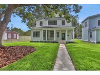 Charming two-story home with a welcoming front porch and meticulously manicured lawn at 731 S Missouri Ave, Lakeland, FL 33815