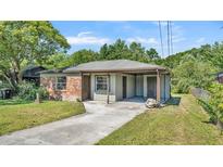 Charming single-story brick home with a covered carport and a well-maintained front yard at 1017 Fleming Ave, Lakeland, FL 33815