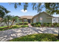 Charming single-story home with stone accents, mature landscaping, and a spacious driveway at 1922 Matthew Ct, Lakeland, FL 33813