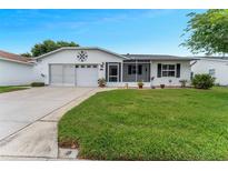 Charming single-story home featuring a well-maintained lawn, attached garage, and a cozy screened-in porch at 3487 Highland Fairways Blvd, Lakeland, FL 33810