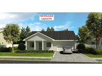 Charming single-story home featuring a neutral palette, well-manicured lawn, and attached garage, perfect for comfortable living at 5920 Cormorant Ct, Lakeland, FL 33809