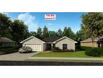 The Ibis model showcases a charming one-story exterior with a two-car garage and lush landscaping at 5921 Cormorant Ct, Lakeland, FL 33809