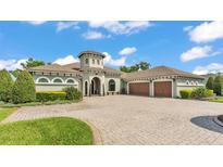 Stunning single-story home boasts a circular driveway and attached two-car garage at 6475 Avalon Woods Dr, Lakeland, FL 33813